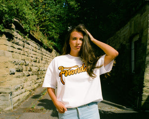 Oversized Friends Logo T-Shirt on body, portrait of woman wearing outside